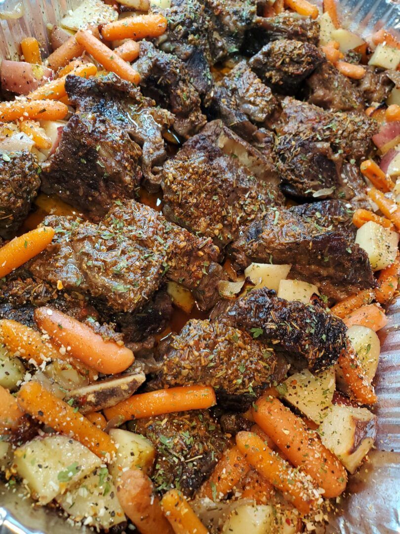 A close up of meat and vegetables on the grill